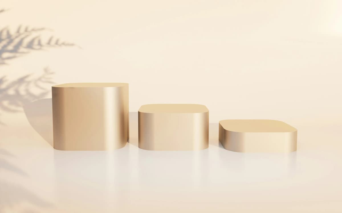 Three cream pedestals in soft light
